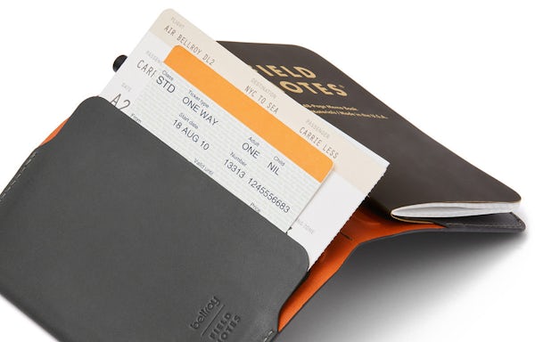 Everyday Inspiration leather cover open with a boarding pass and ticket sticking out of the pocket