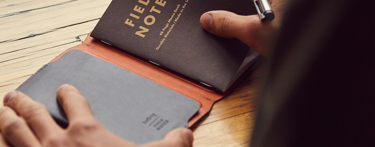 Close up photo of a person opening the Everyday Inspiration leather cover