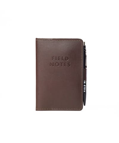 Daily Carry leather notebook cover with Field Notes stamped in black and with attached pen loop.