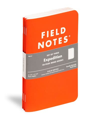 Expedition Edition waterproof notebook with orange cover shown at an angle.