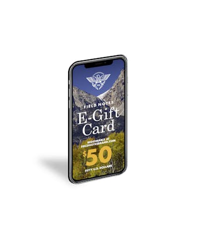 Field Notes electronic Gift Card depicted on a smartphone, tilted at an angle.